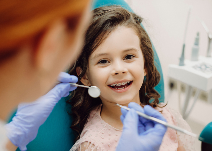 pediatric dentist examining baby teeth