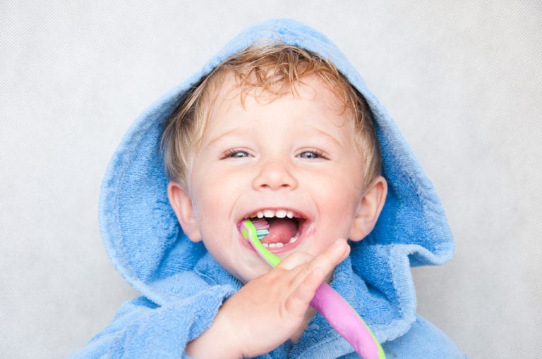 pediatric dentist examining baby teeth